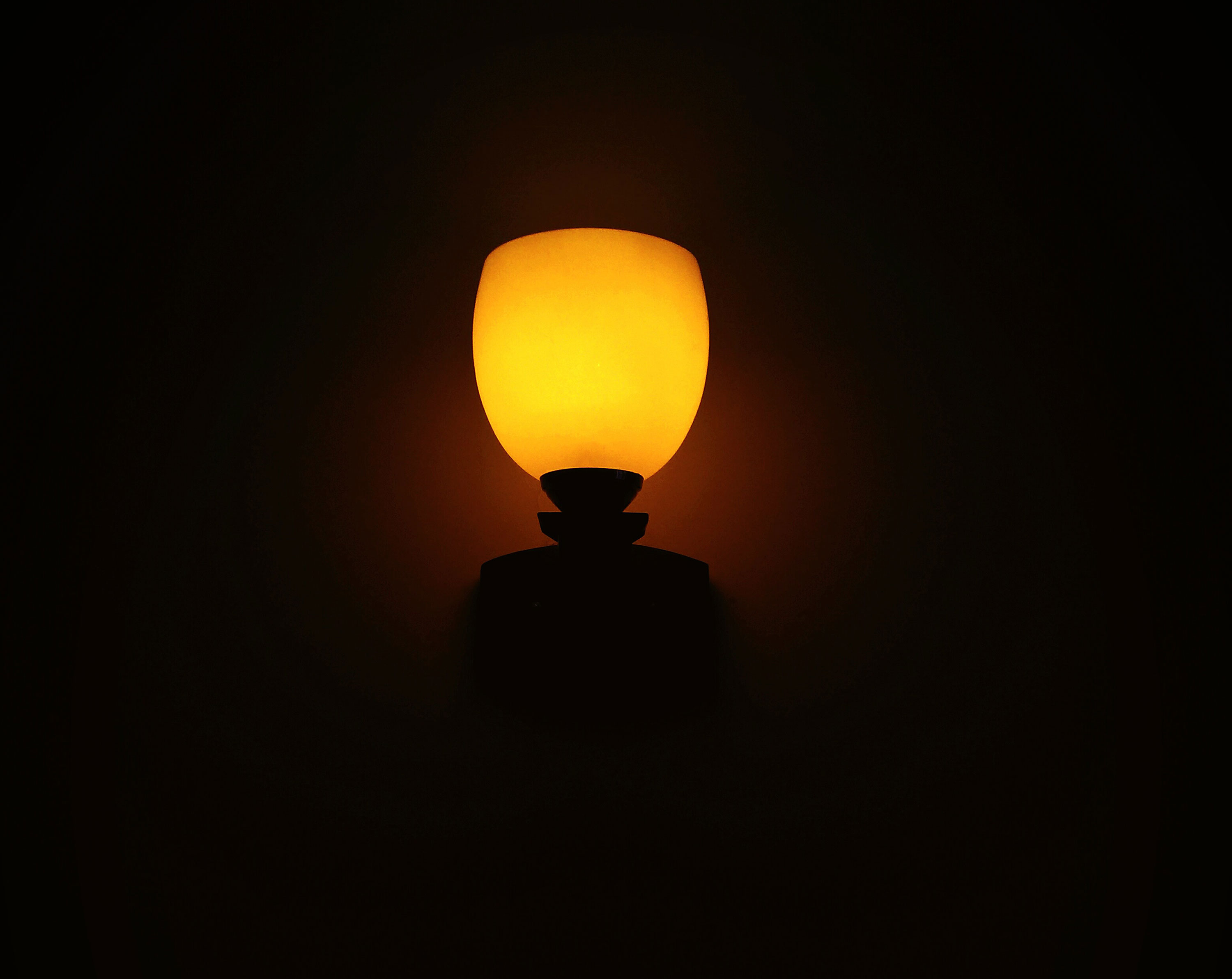 Orange Night lamp glowing on wall